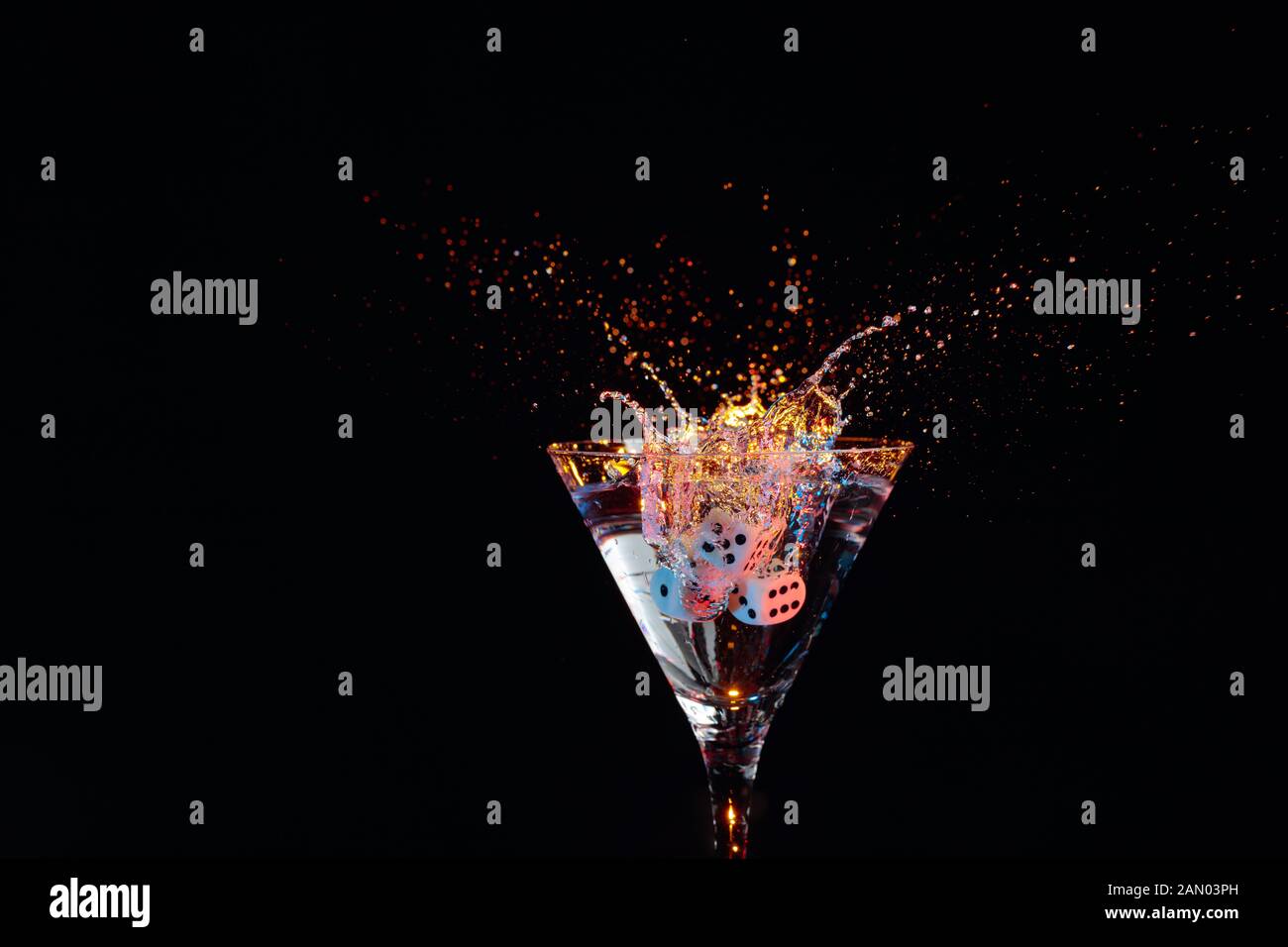 Martini in a fancy glass with blue game dice Stock Photo - Alamy