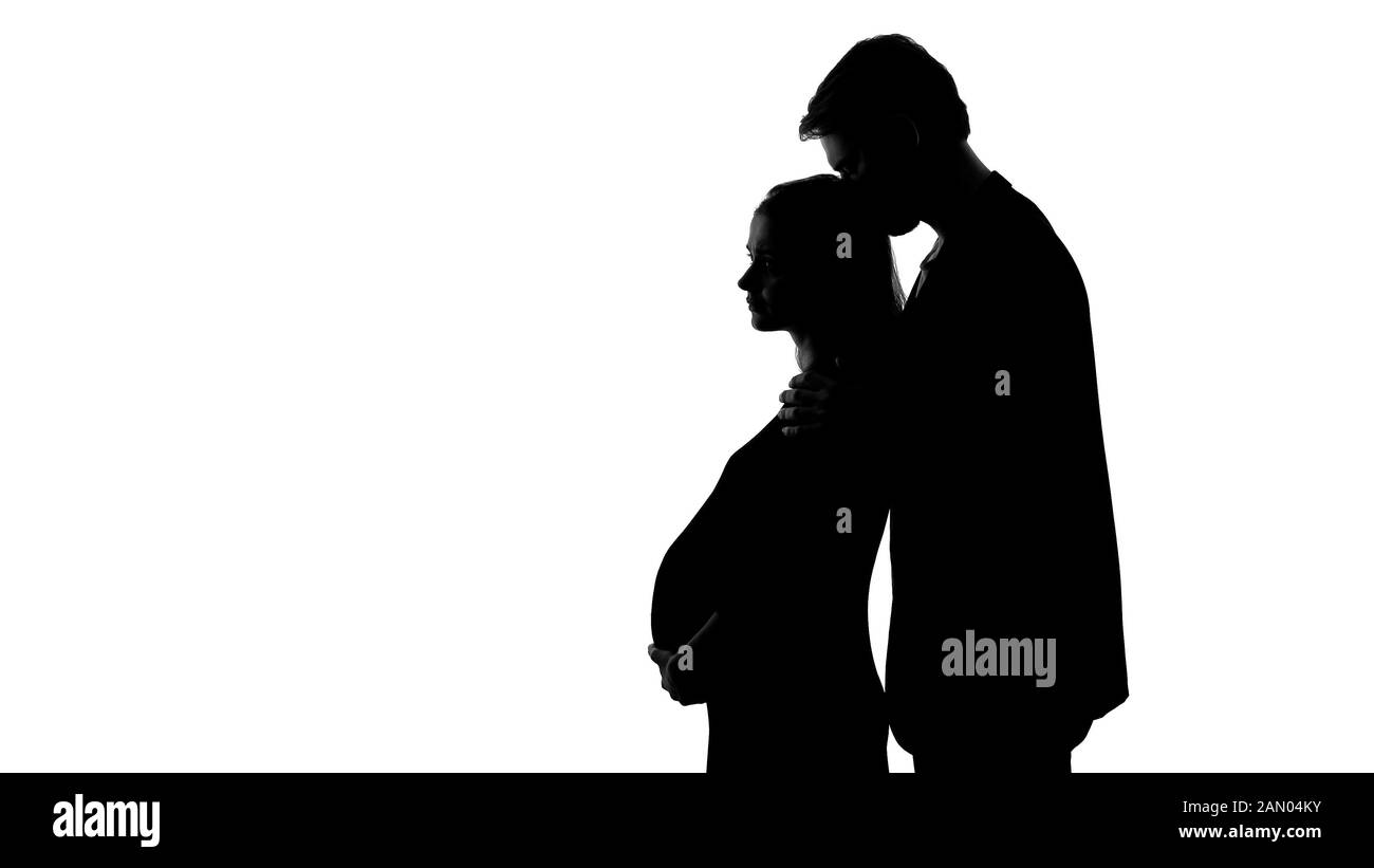 Silhouette of young male kissing sad pregnant woman, unhappy relationship Stock Photo