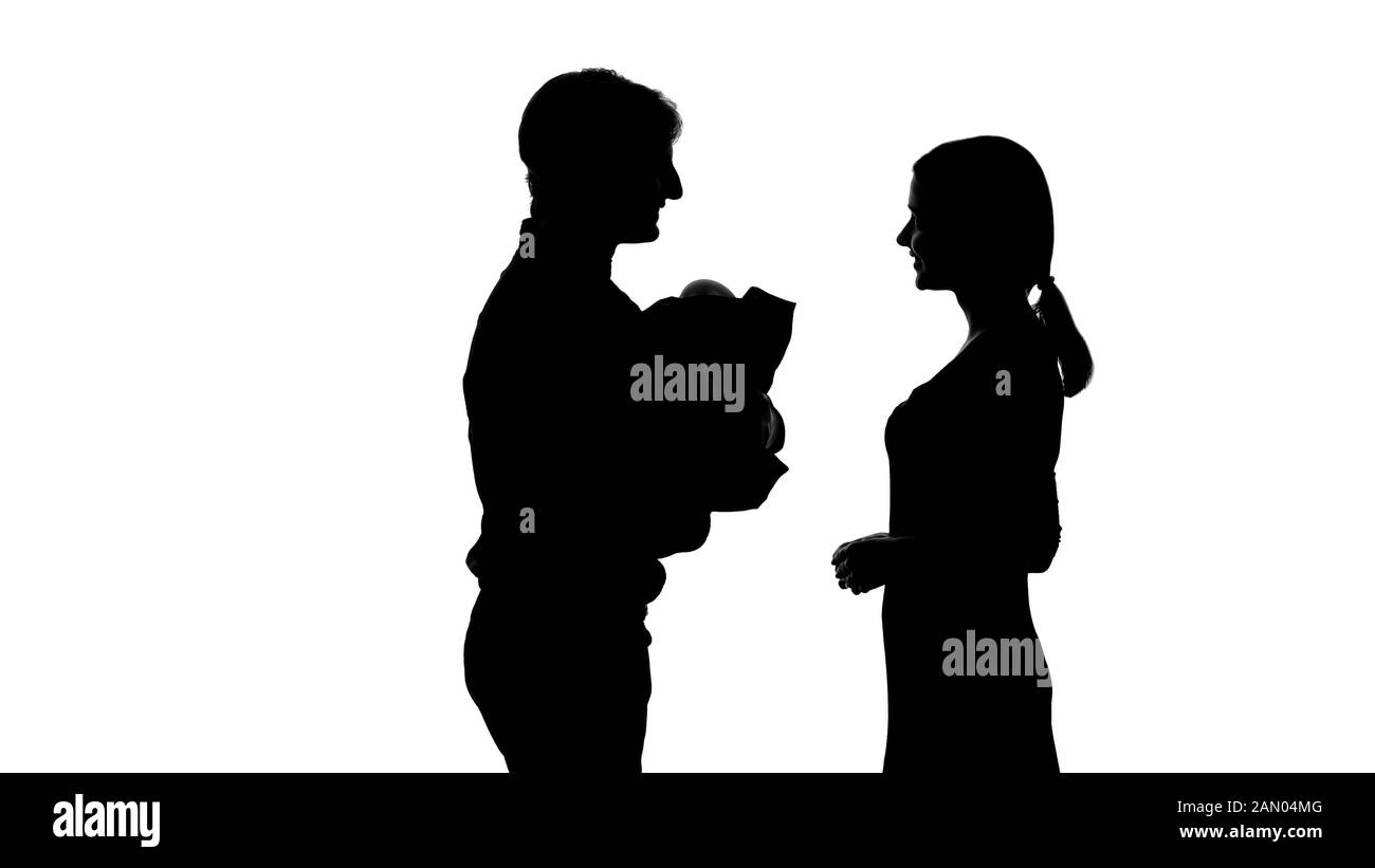 Woman giving newborn baby to happy father, surrogacy arrangement, agreement Stock Photo