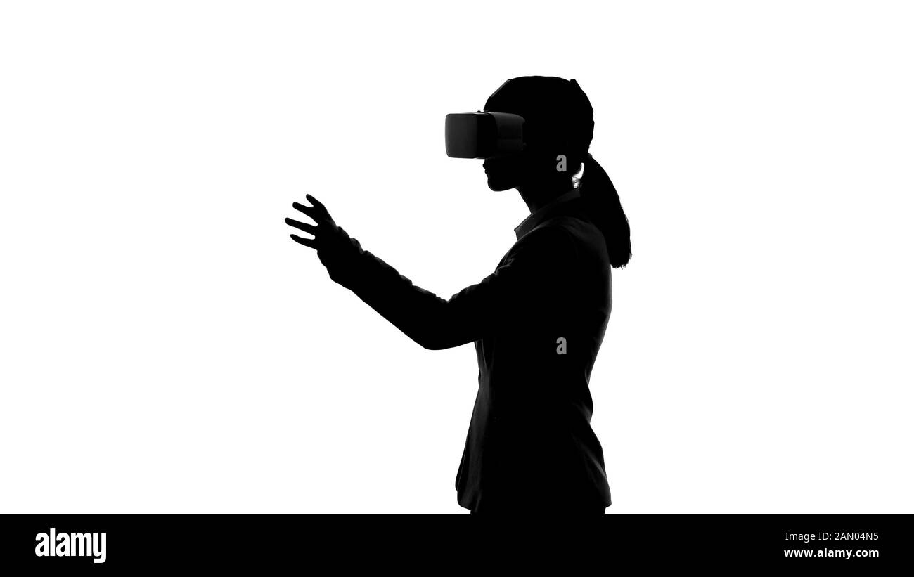 Businesswoman in virtual reality headset entering options, startup planning Stock Photo