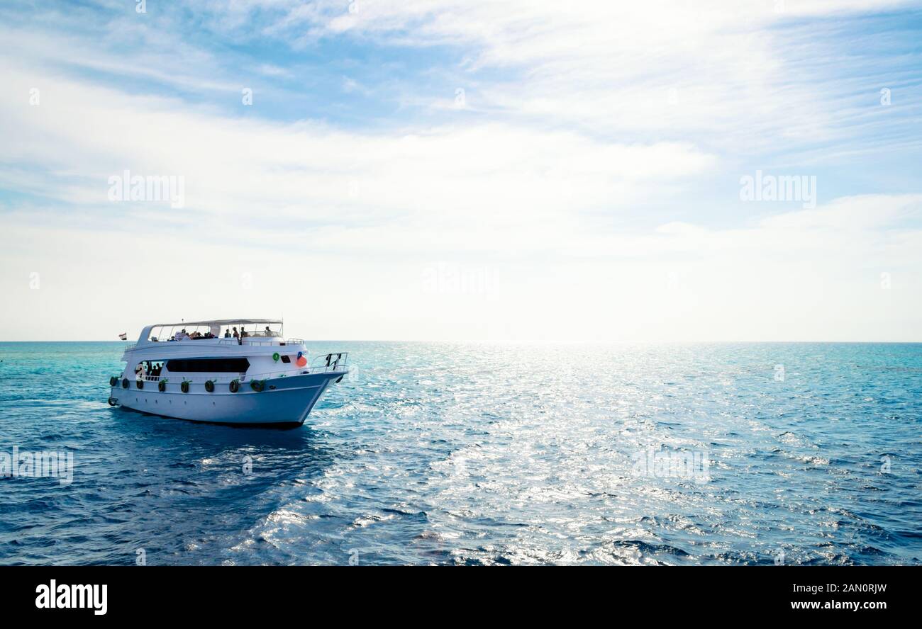 white cruise tourist boat on the background of the coast in the Red Sea ...