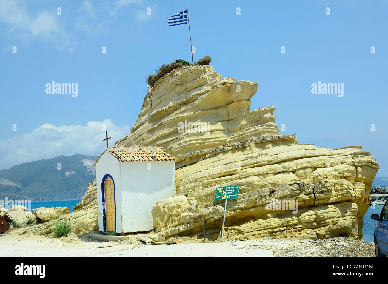 Greece, Zakynthos Island, chapel and rock with Greek flag in Agia Sostis Stock Photo
