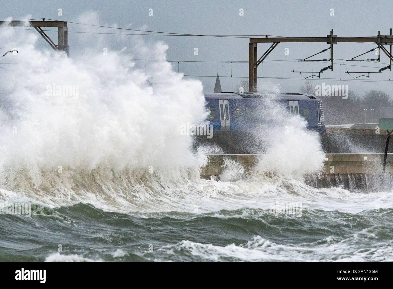Saltcoats, North Ayrshire, Scotland, UK. 15th Jan, 2020. UK weather: final train passing through Saltcoats, Scotland just before trains were cancelled on this section of line due to extreme weather Credit: Kay Roxby/Alamy Live News Stock Photo