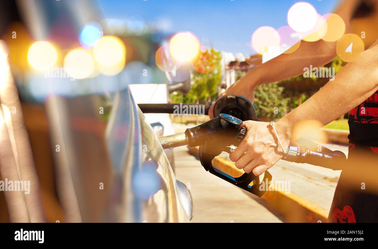 Woman pouring gasoline into the car at the service station.fuel station