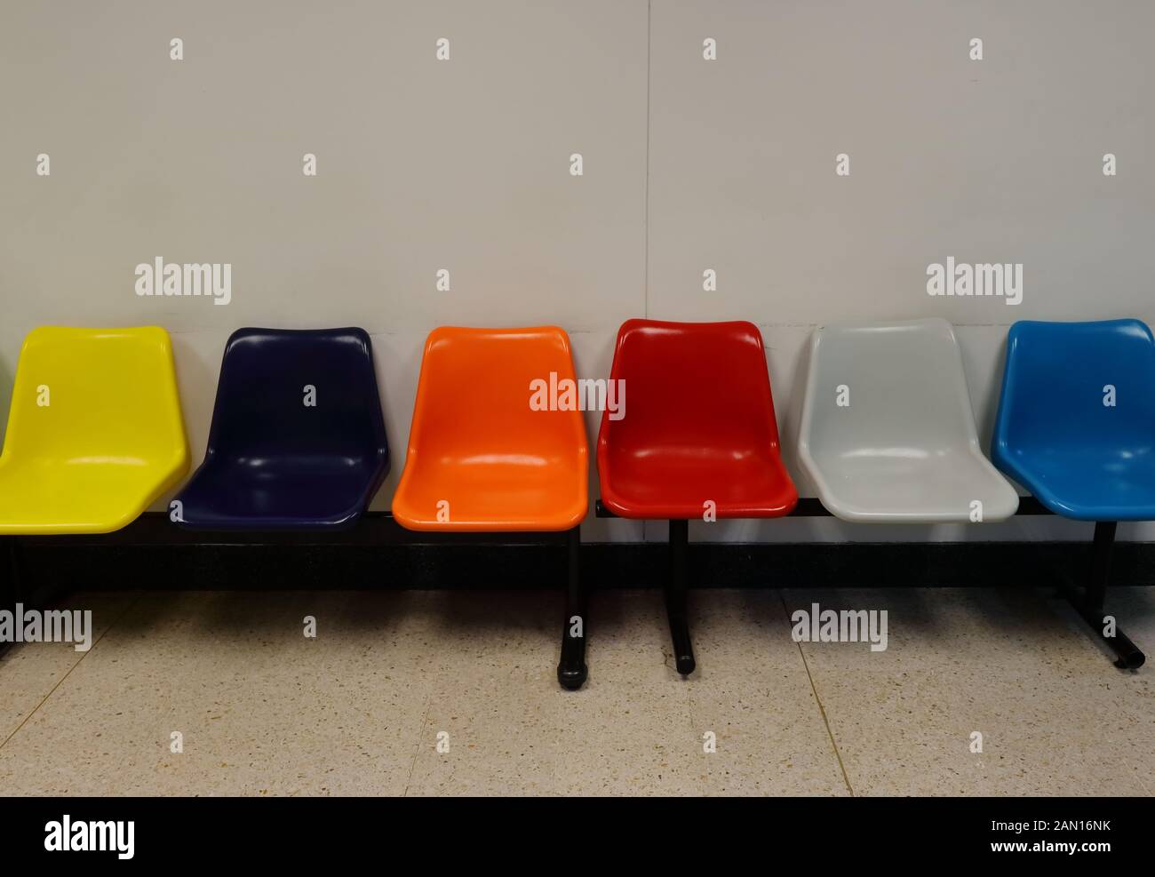 Row of multi colored chairs in waiting room, relaxation concept Stock Photo