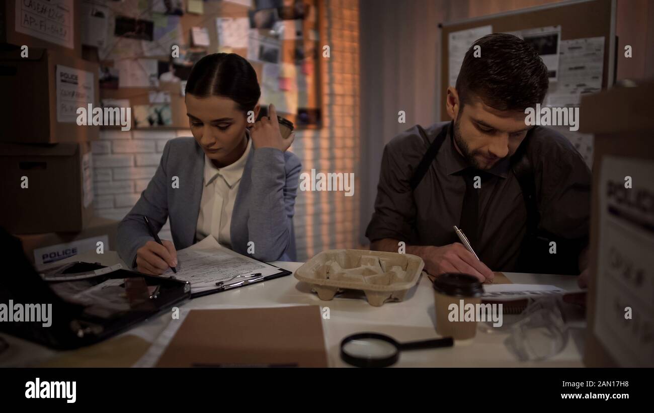 Investigation office partners drinking coffee and preparing documents for arrest Stock Photo