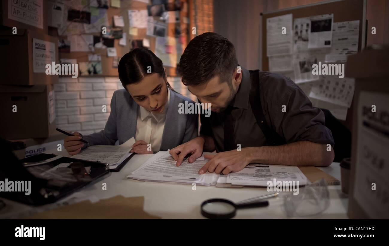 Two defense lawyers working overnight and finding answer in top secret files Stock Photo