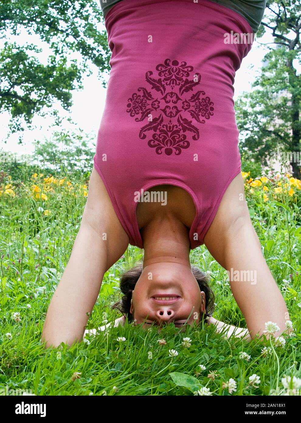 A woman doing a headstand Stock Photo