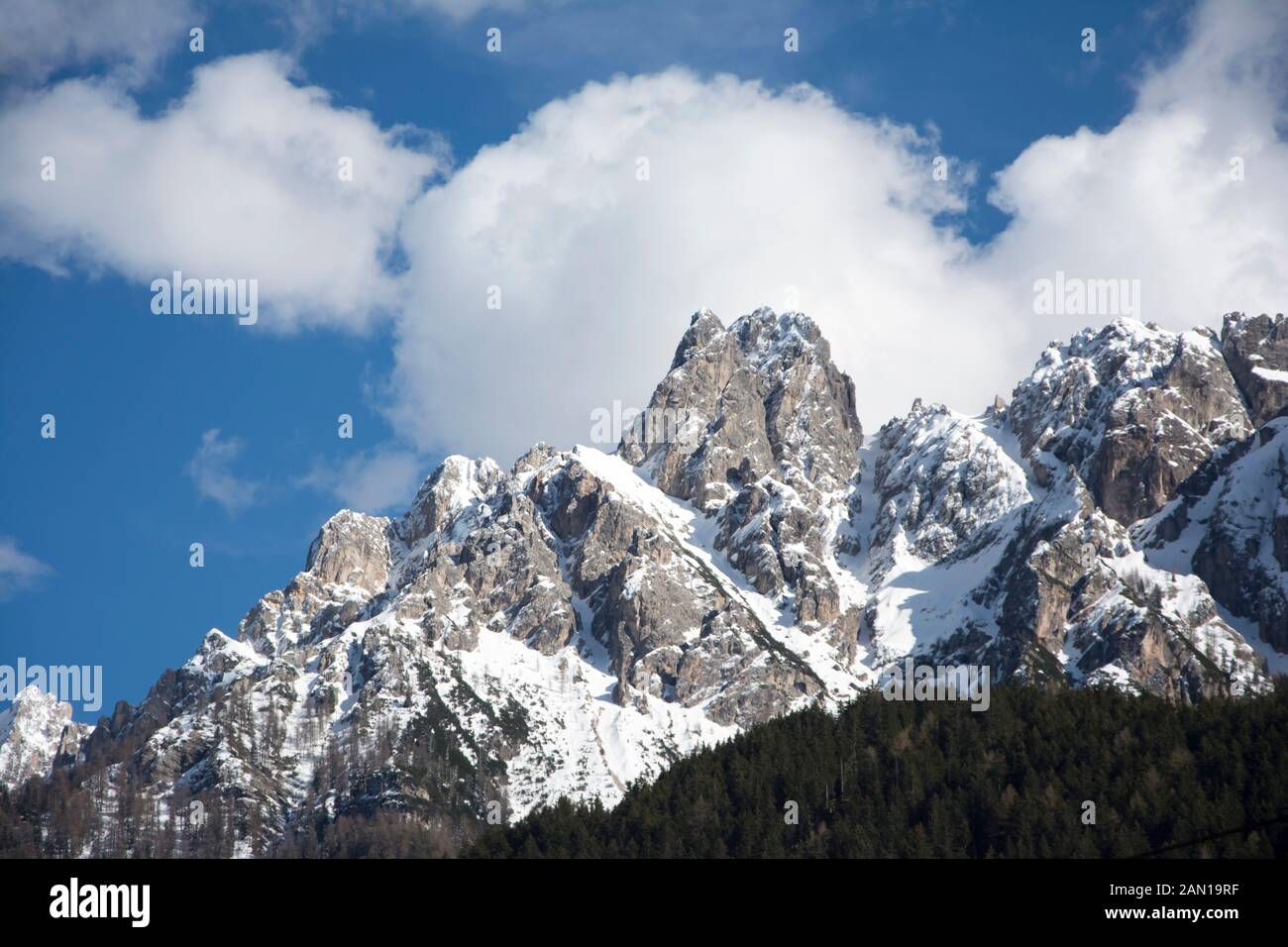 Views of snow-capped mountains and trees from Toblach / Dobbiaco, in south Tirol Stock Photo