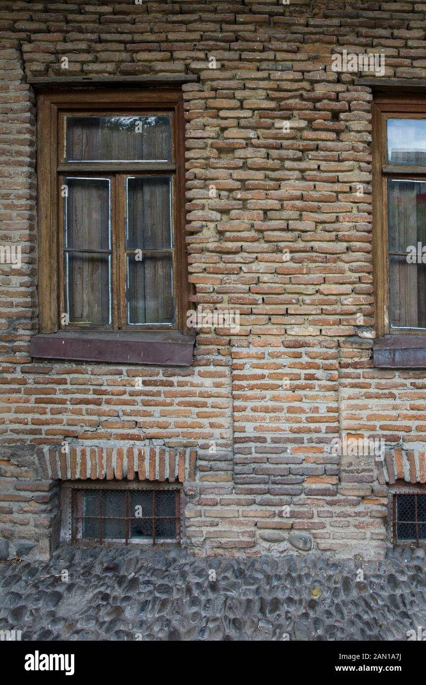 Closeup of the old brick house with wooden windows Stock Photo - Alamy