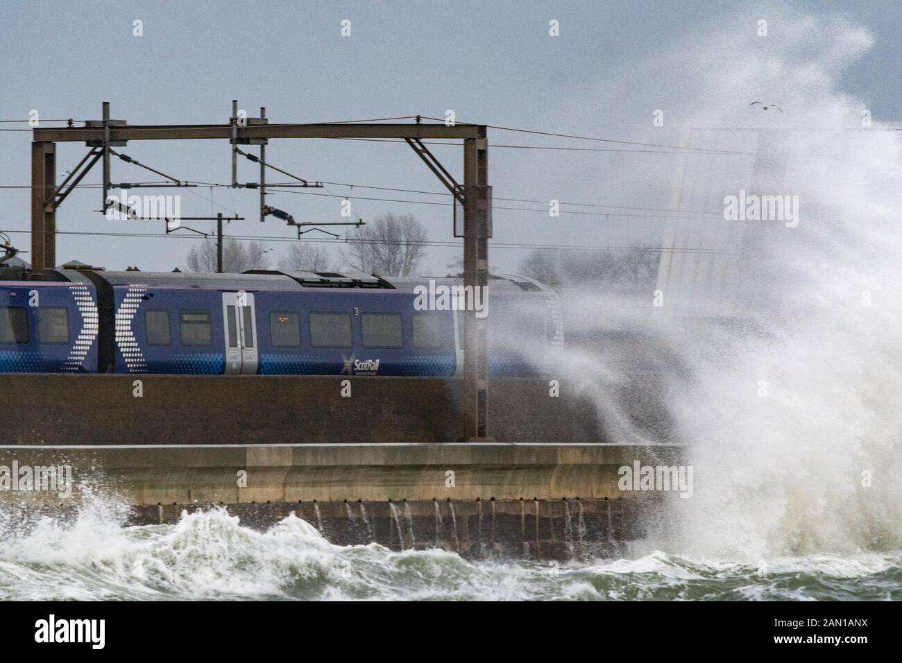 Saltcoats, North Ayrshire, Scotland, UK. 15th Jan, 2020. UK weather: final train passing through Saltcoats, Scotland just before trains were cancelled on this section of line due to extreme weather Credit: Kay Roxby/Alamy Live News Stock Photo