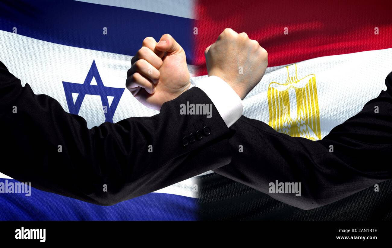 Israel vs Egypt confrontation, countries disagreement, fists on flag