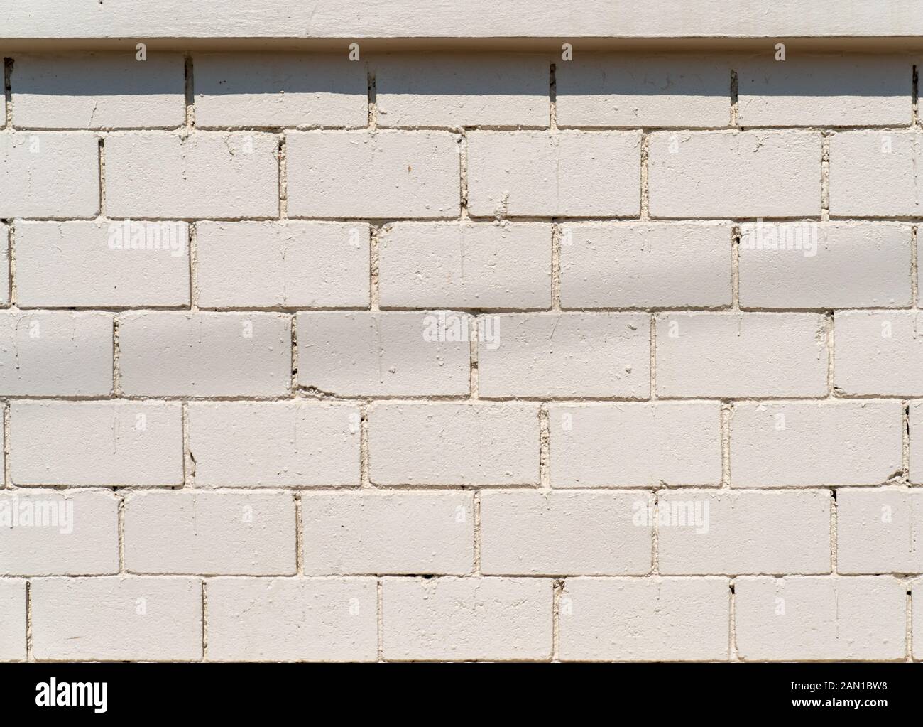 WhiteCream Cement wall with brick pattern at outdoor field for