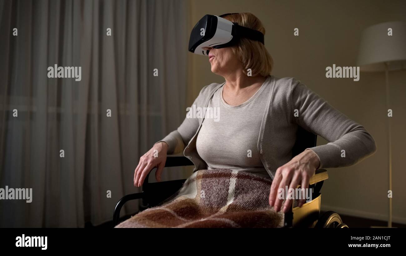 Woman in wheelchair wearing vr headset for the first time, happy and ...