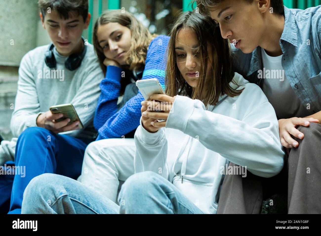 Friends using smartphones Stock Photo