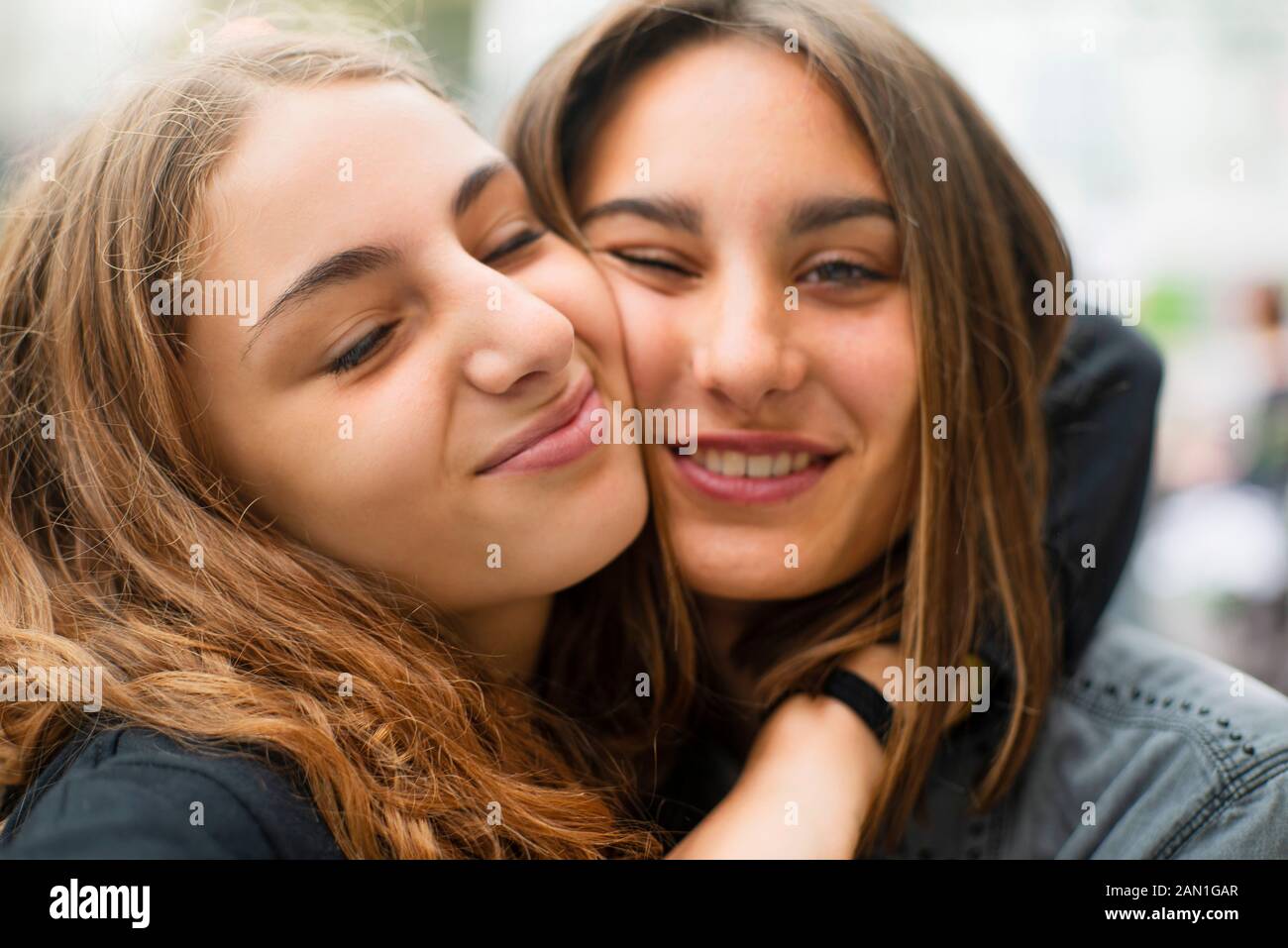 Friends embracing outdoors Stock Photo