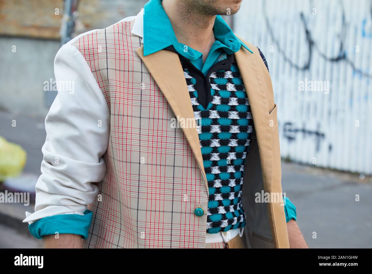 MILAN, ITALY - JANUARY 11, 2019: Man with blue and white sweater and checkered jacket before Marni fashion show, Milan Fashion Week street style Stock Photo