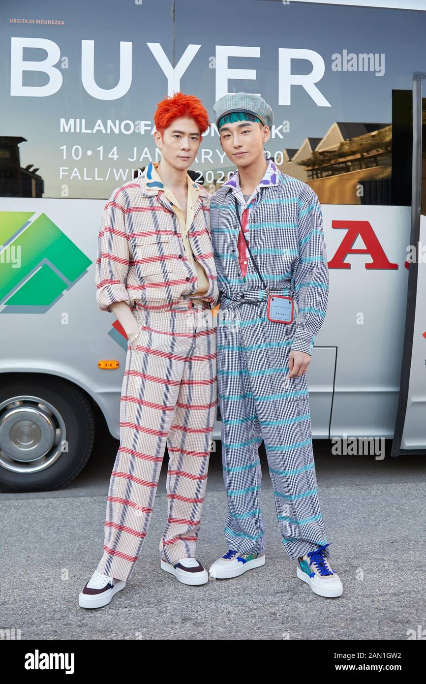 MILAN, ITALY - JANUARY 11, 2019: Men with checkered overalls before Marni fashion show, Milan Fashion Week street style Stock Photo