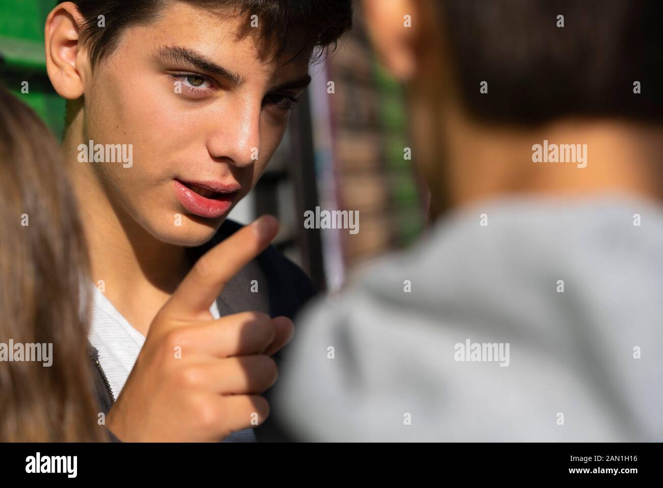 Close-up of boy talking to his friend Stock Photo