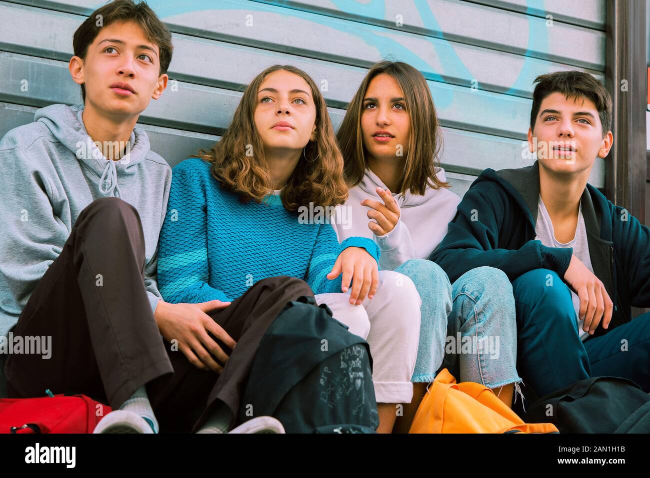 Friends sitting outdoors Stock Photo