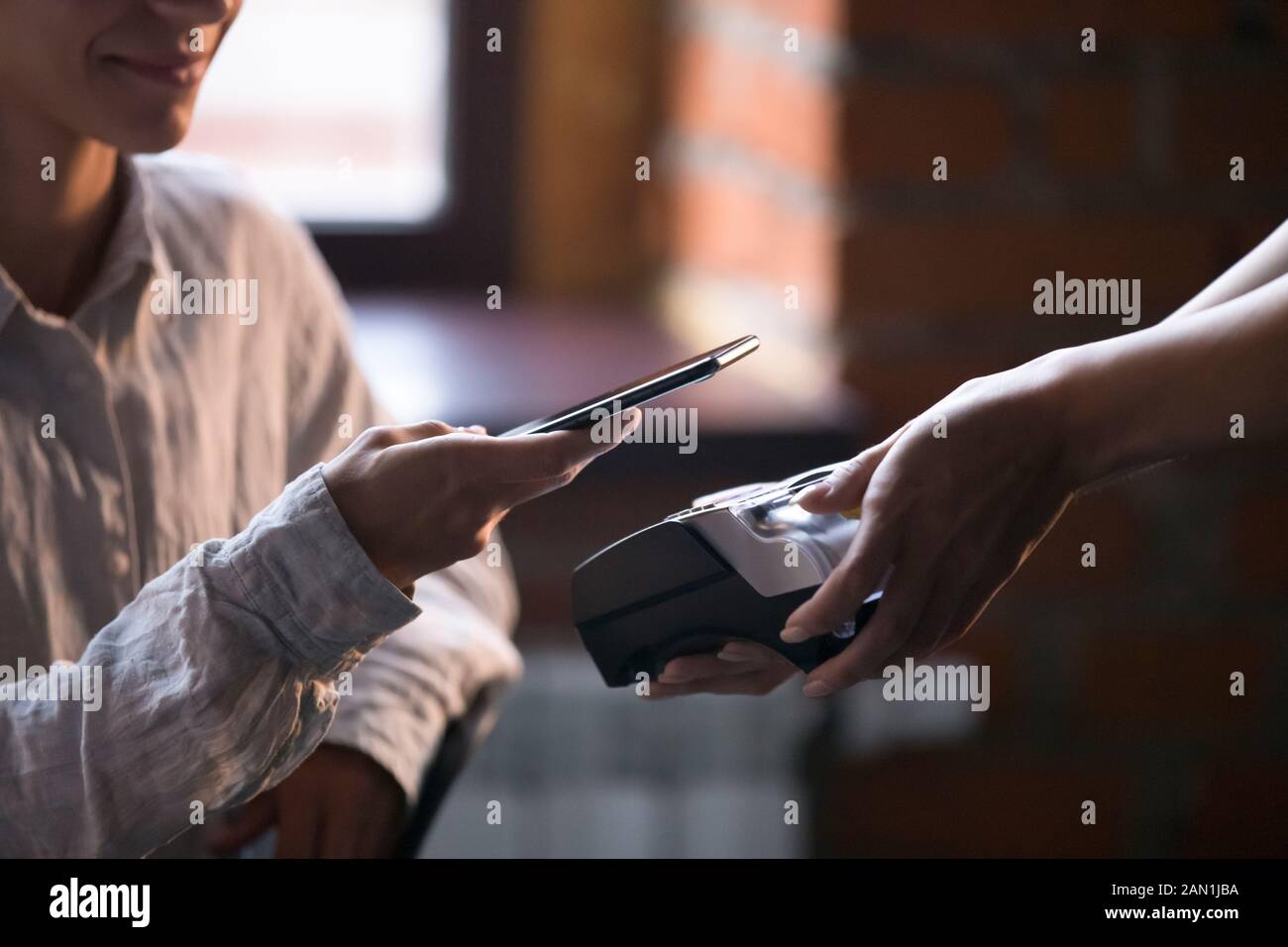 Cafe customer make payment with cellphone nfc technology Stock Photo