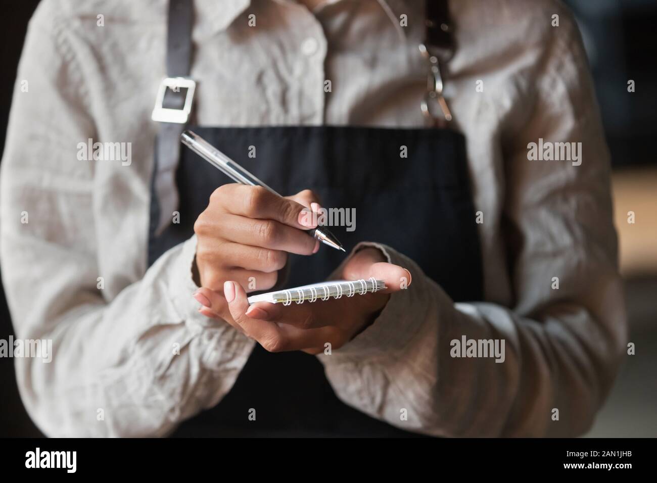 Waitress writing taking order serving customer in cafe Stock Photo