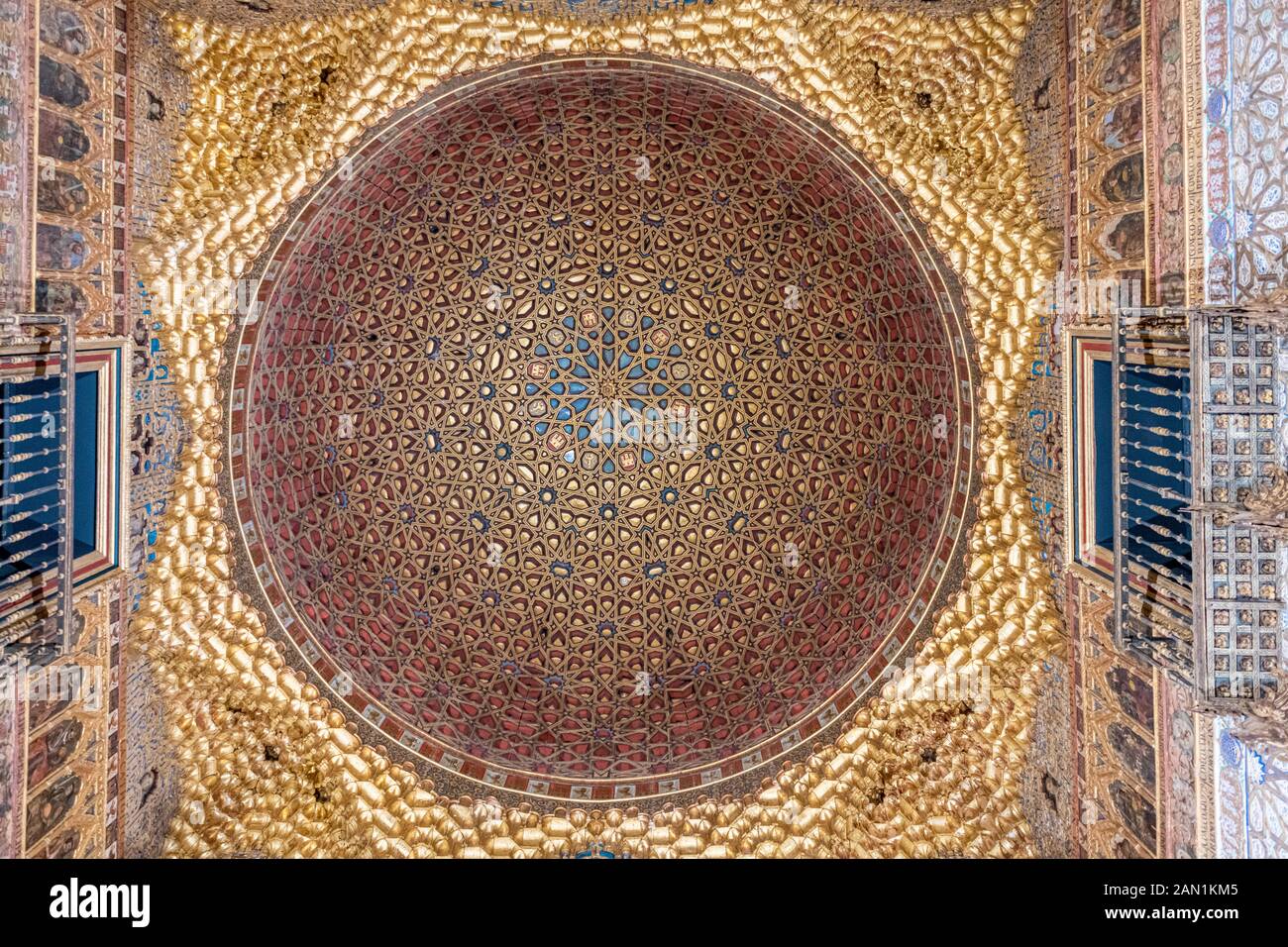 The stunning carved and gilded interlaced wooden dome in the Salón de los Embajadores of the Alcazar Palace's Palacio Del Rey Don Pedro. Stock Photo