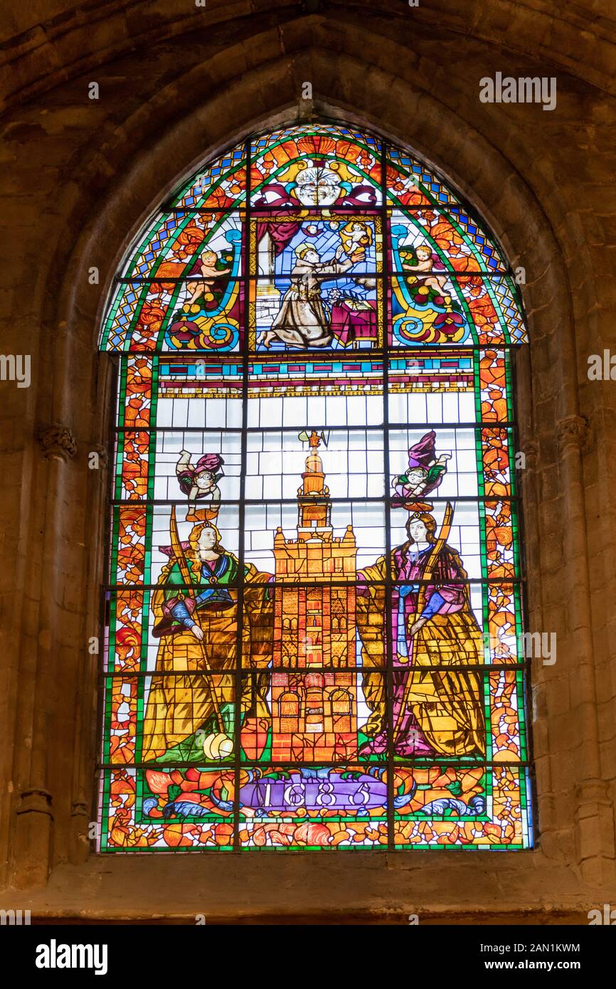 The 1685 stained glass window in the Chapel of St Anthony, of the two Sevillian martyrs, Saints Justa and Rufina, protecting the iconic Giralda Stock Photo