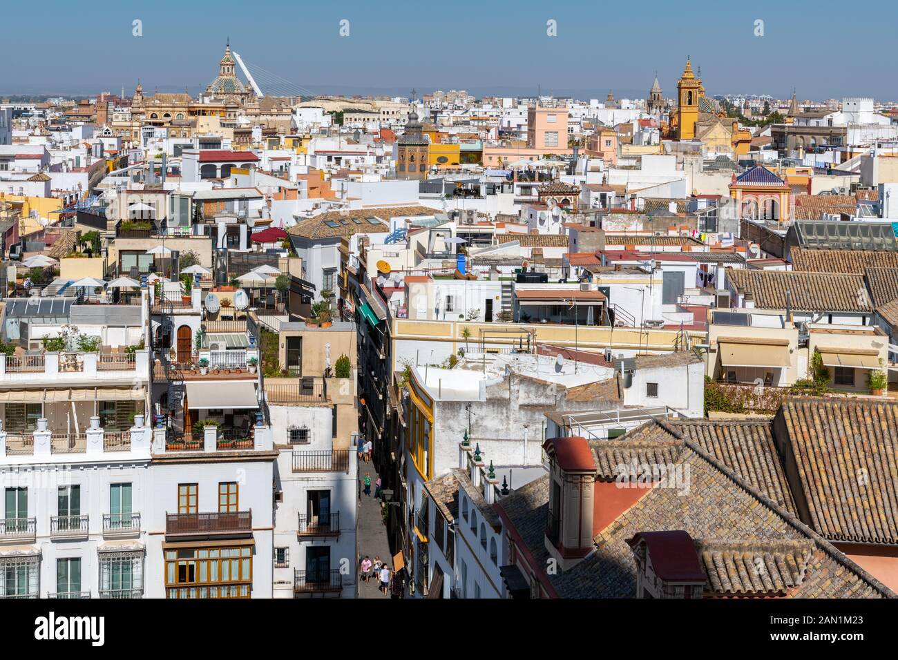 With Iglesia del Salvador & Puente del Alamillo on the horizon, Seville's colourful, narrow streets and church towers stretch out below the Giralda Stock Photo