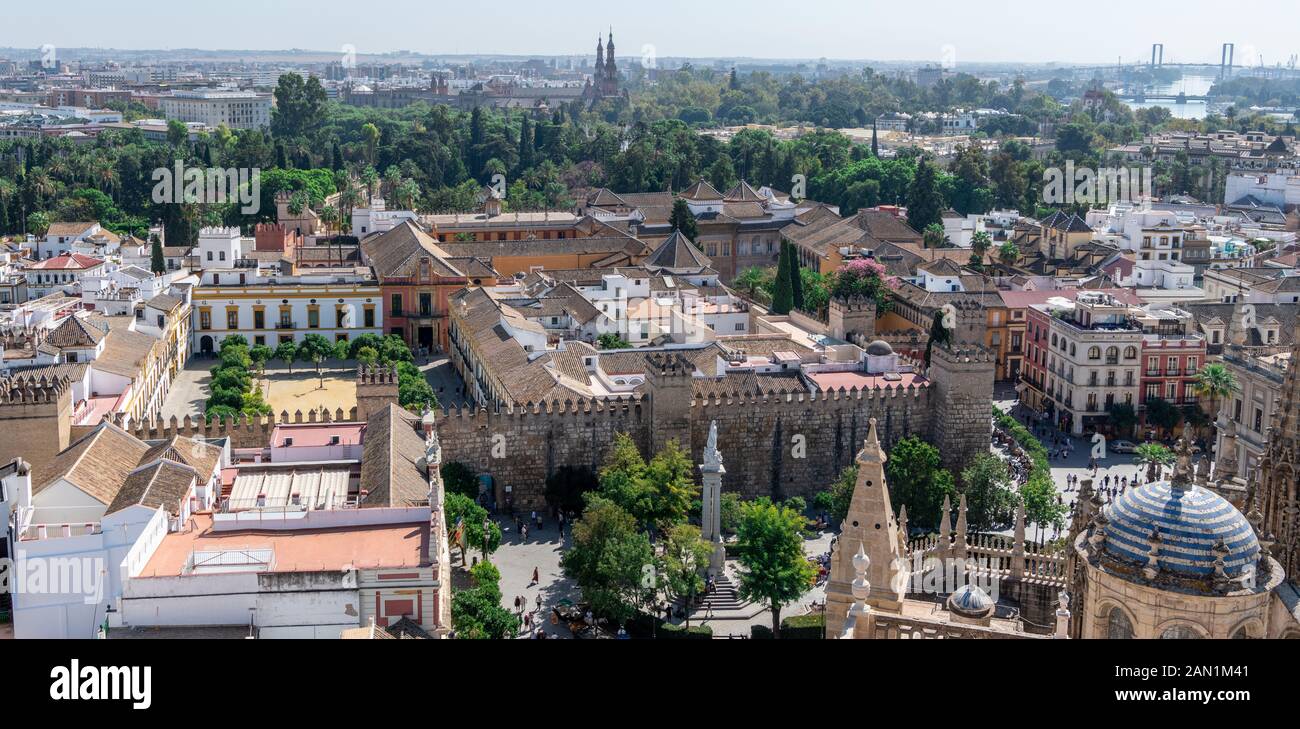 A view, from the Giralda, of the Main Sacristy of Seville Cathedral. Plaza del Triunfo and Real Alcázar with the distant towers of Plaza De Espana. Stock Photo