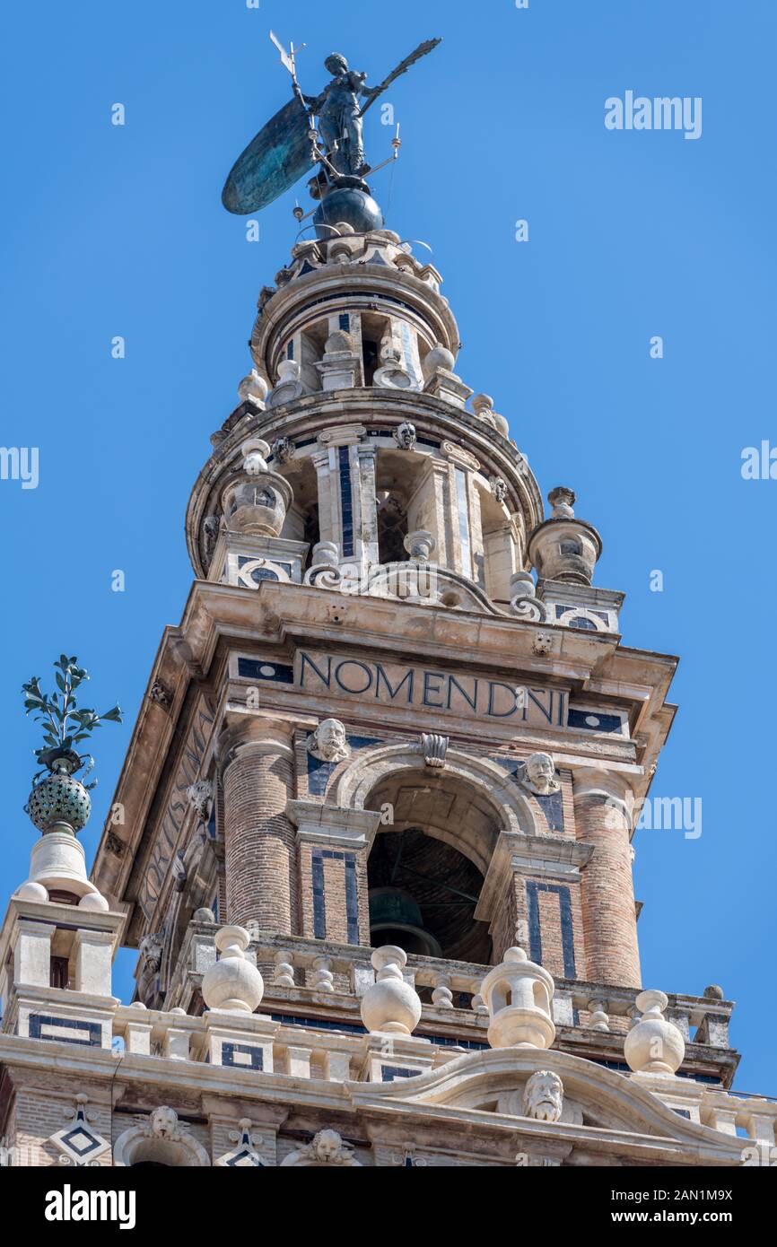 Detail of the belfry of Seville Cathedral with its bronze statue of 'Faith', its weather vane or Giraldillo, which gives the tower its name, 'Giralda' Stock Photo
