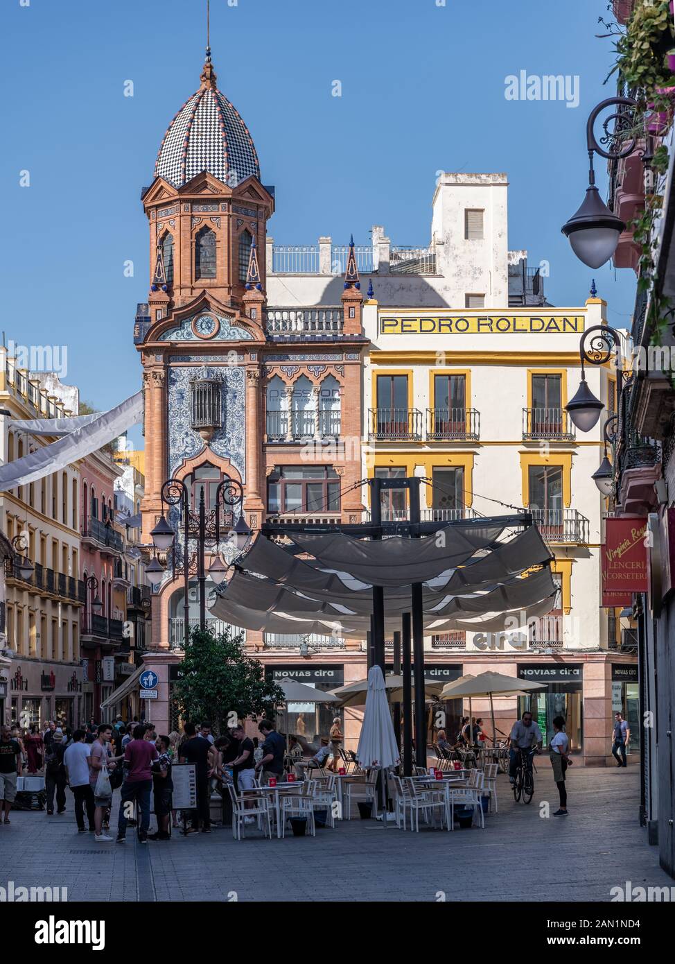 Colourful and ornate buildings line the northern end of Plaza Jesús de la Pasión in Seville in late afternoon October sunshine. Stock Photo
