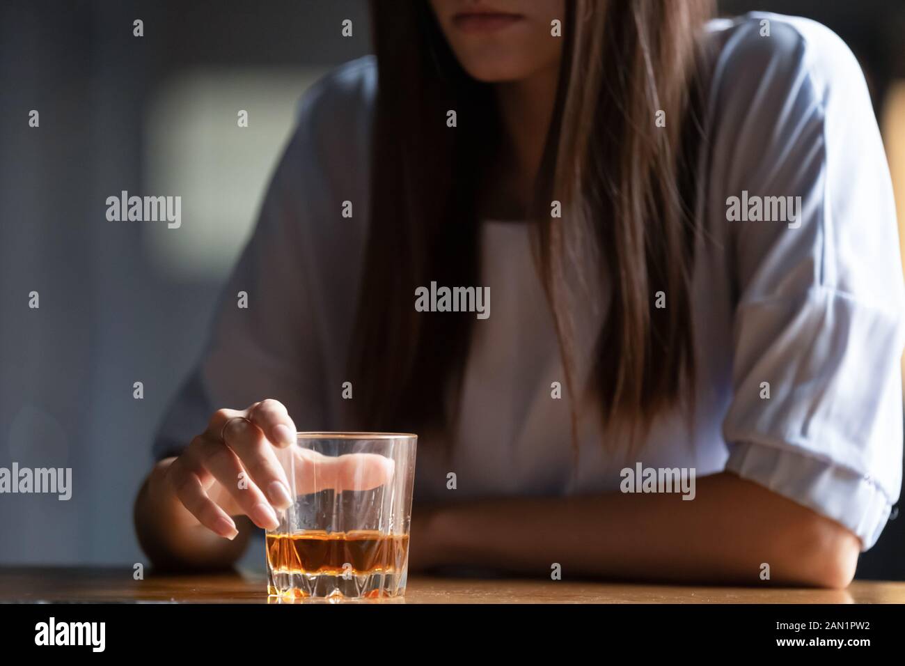 Close up of woman drinking alcohol at bar counter Stock Photo