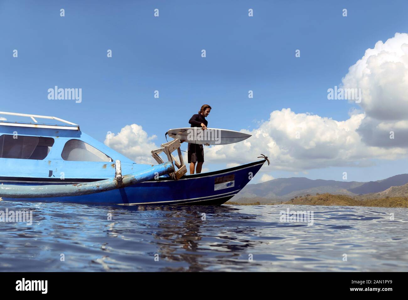 Man standing at the boat into sea Stock Photo - Alamy