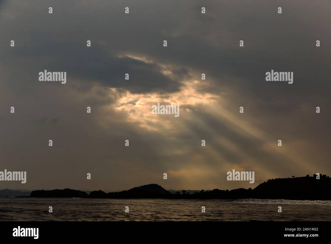 Sunlight shining through dark clouds Stock Photo