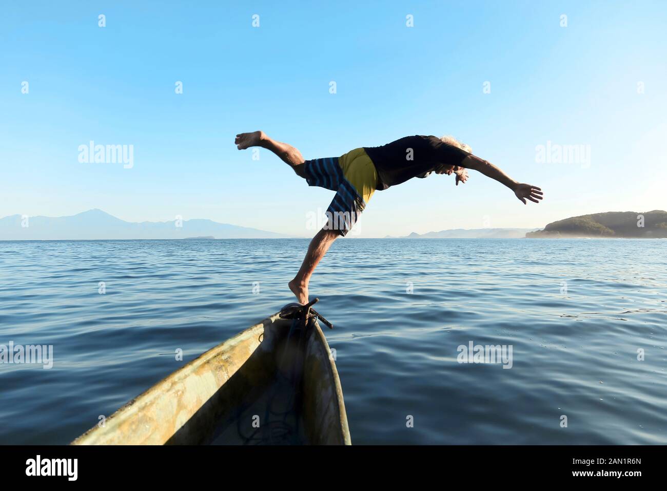 Man jumping from boat into sea Stock Photo Alamy