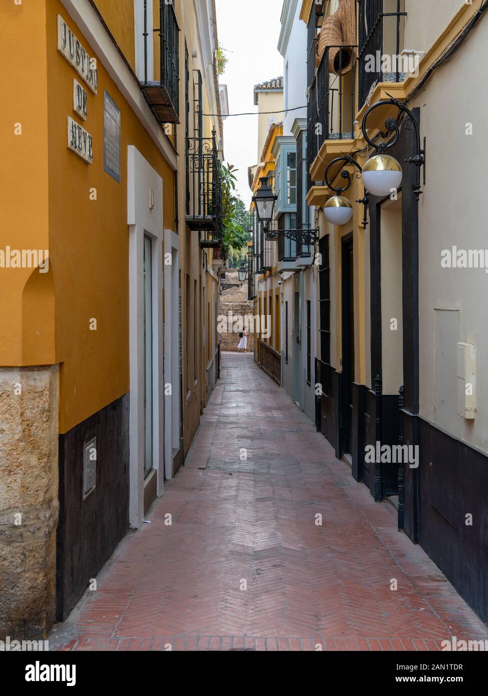 The colourful, but narrow, Calle Justino de Neve in Seville's Barrio de Santa Cruz. Stock Photo