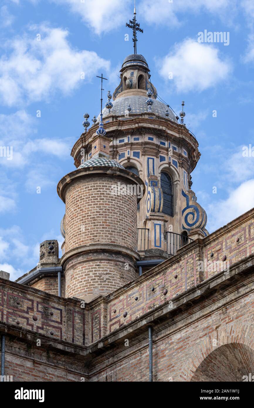 The decorated dome, cupola and towers of Iglesia de la Anunciación rise above the relatively austere facade of the church. Stock Photo