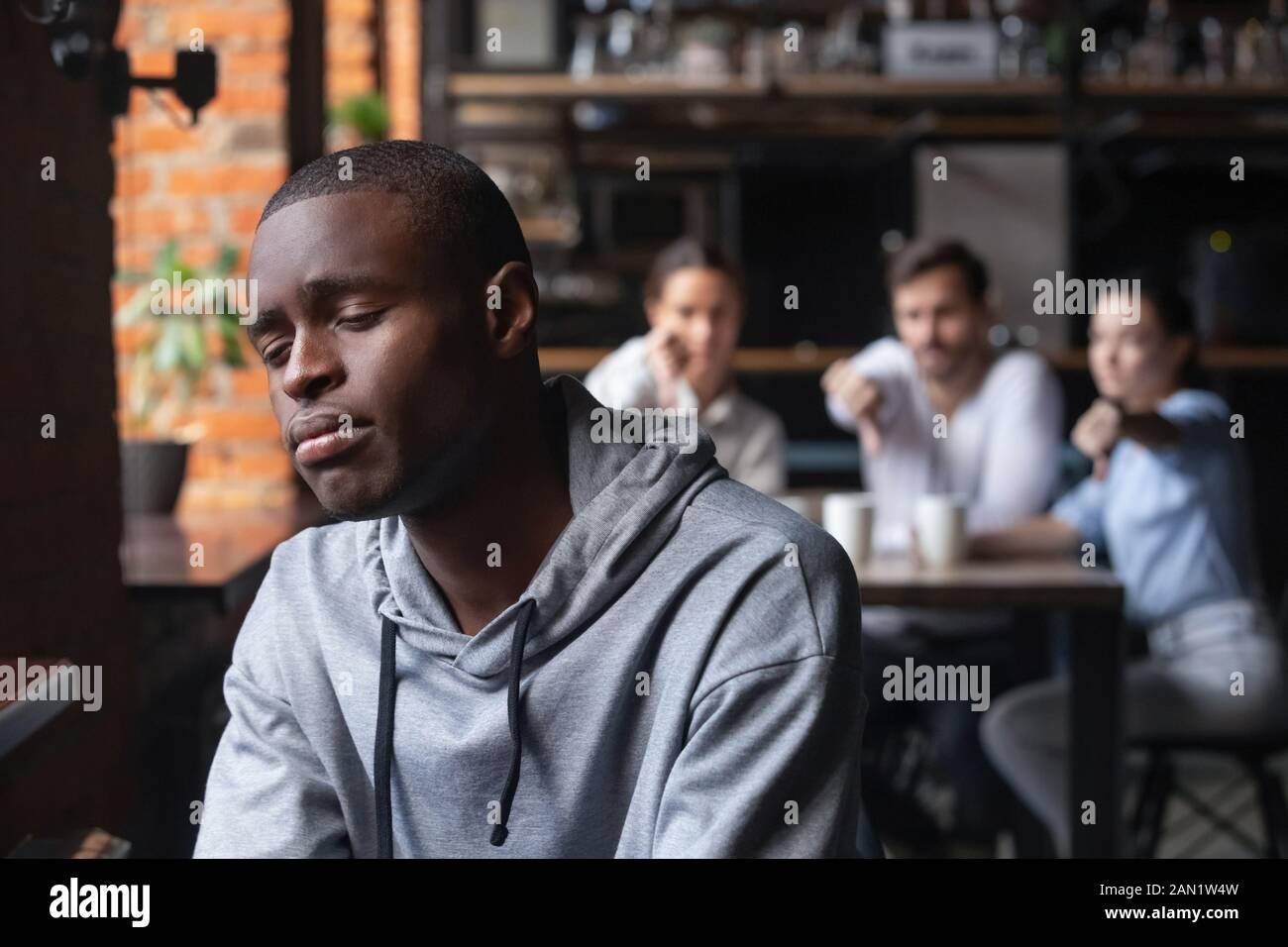 Depressed male guy suffer from bullying feel discriminated Stock Photo
