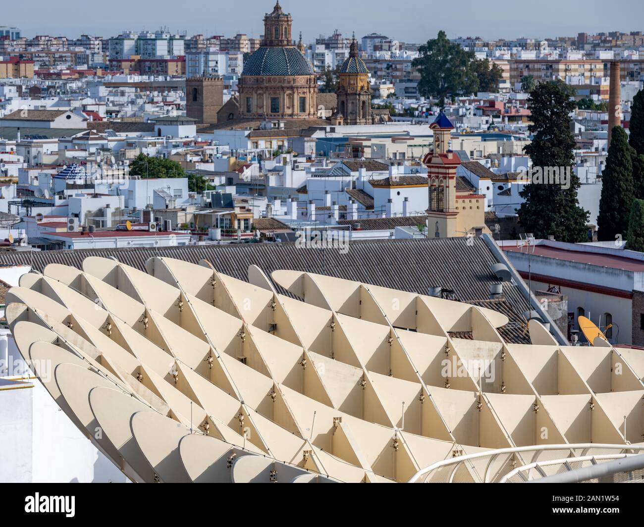 Jurgen Mayer's Metropol Parasol in Plaza de la Encarnacion contrasts with the dome & lantern of Iglesia de San Luis de los Franceses & ornate belfry Stock Photo