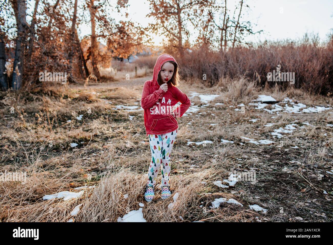 young girl with hand on hip standing in a field Stock Photo - Alamy