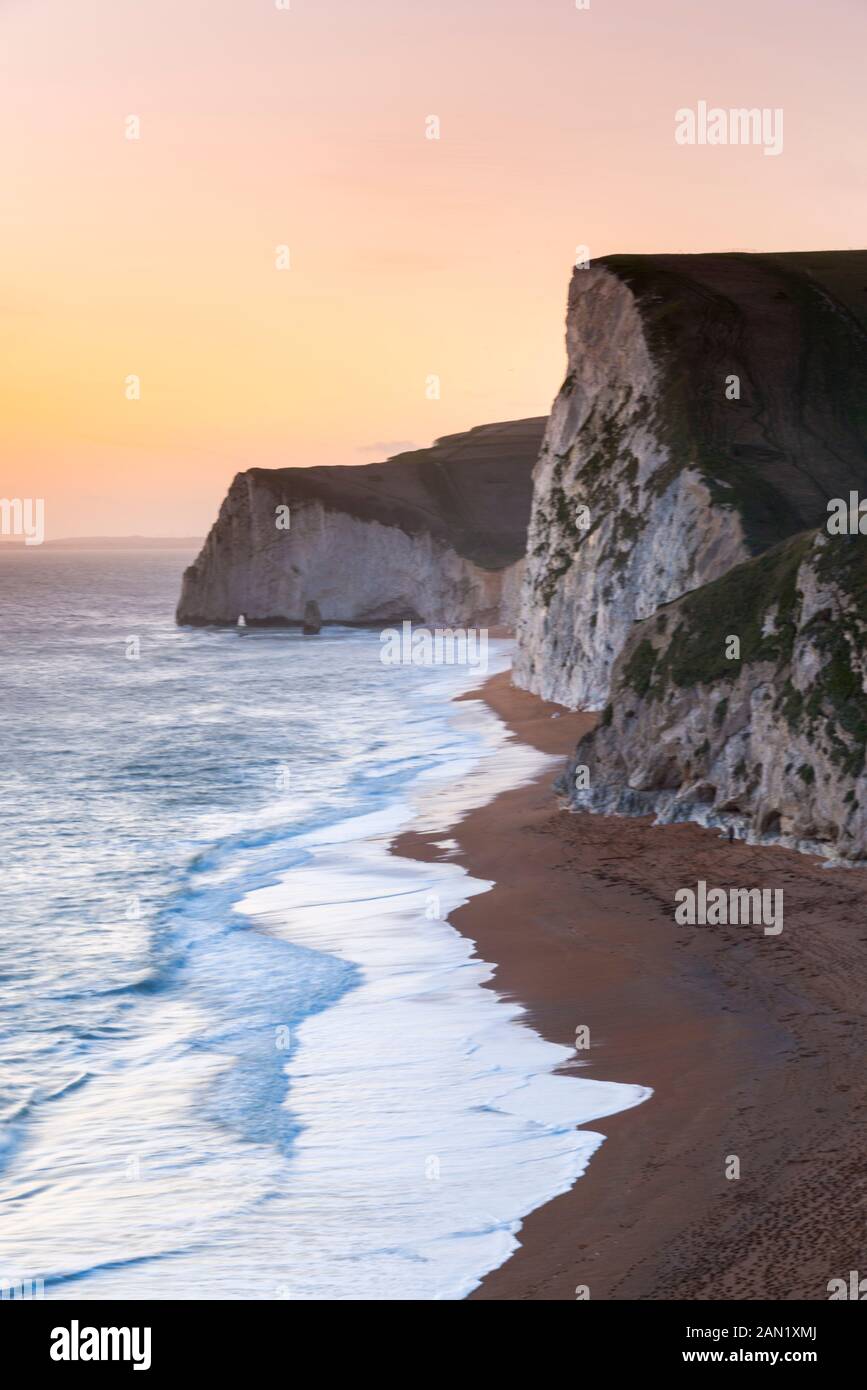 Durdle Door, Lulworth, Dorset, UK.  15th January 2020. UK Weather.  The sky glows orange at sunset at Swyre Head and Bats Head near Lulworth in Dorset.  Picture Credit: Graham Hunt/Alamy Live News Stock Photo