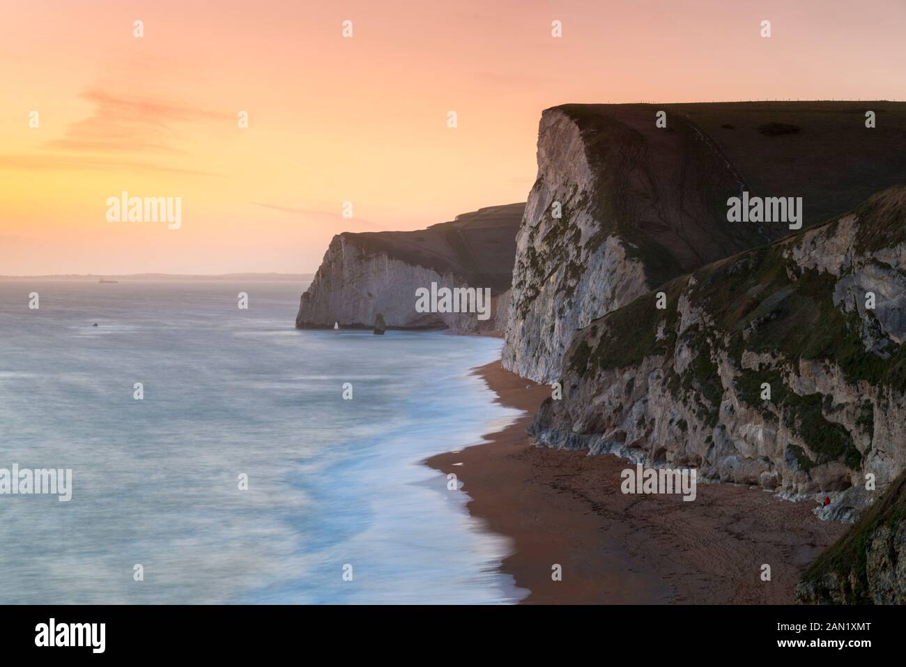 Durdle Door, Lulworth, Dorset, UK.  15th January 2020. UK Weather.  The sky glows orange at sunset at Swyre Head and Bats Head near Lulworth in Dorset.  Picture Credit: Graham Hunt/Alamy Live News Stock Photo
