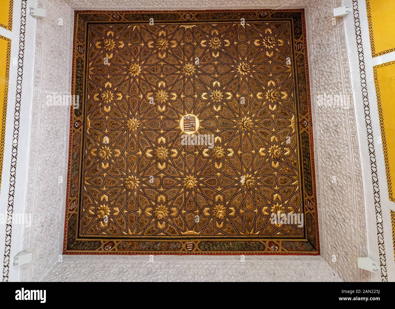 A staggered, ornamental coffered ceiling of Mudejar inspiration in a room in the Casa de Pilatos, Seville. Stock Photo