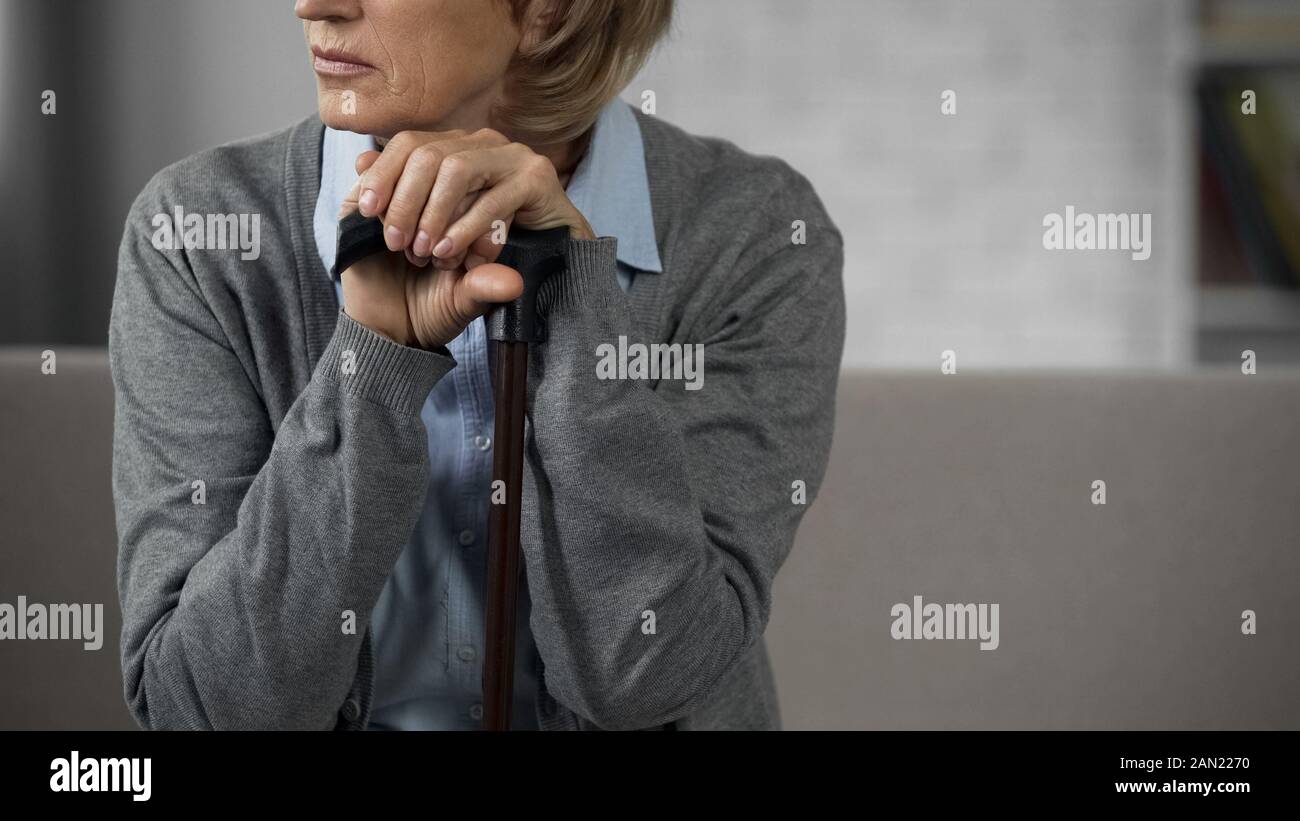 Old hands holding walking stick hi-res stock photography and images - Alamy