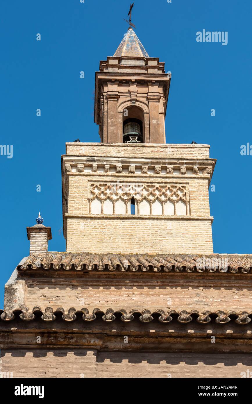 Detail of the terra cotta roof and Giralda-like tower of Iglesia de San Marcos in Seville Stock Photo