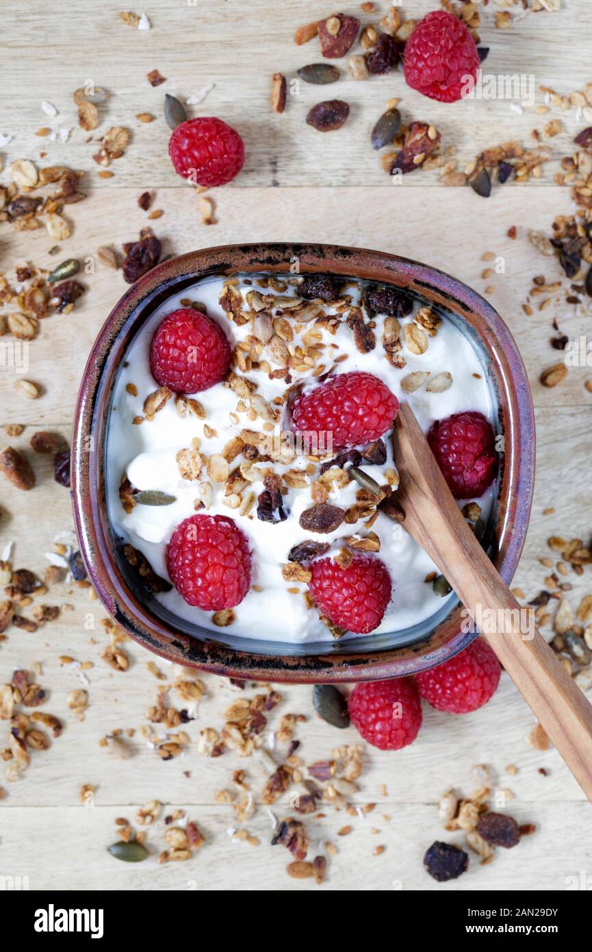 Skyr topped with Raspberries and homemade Granola. Stock Photo