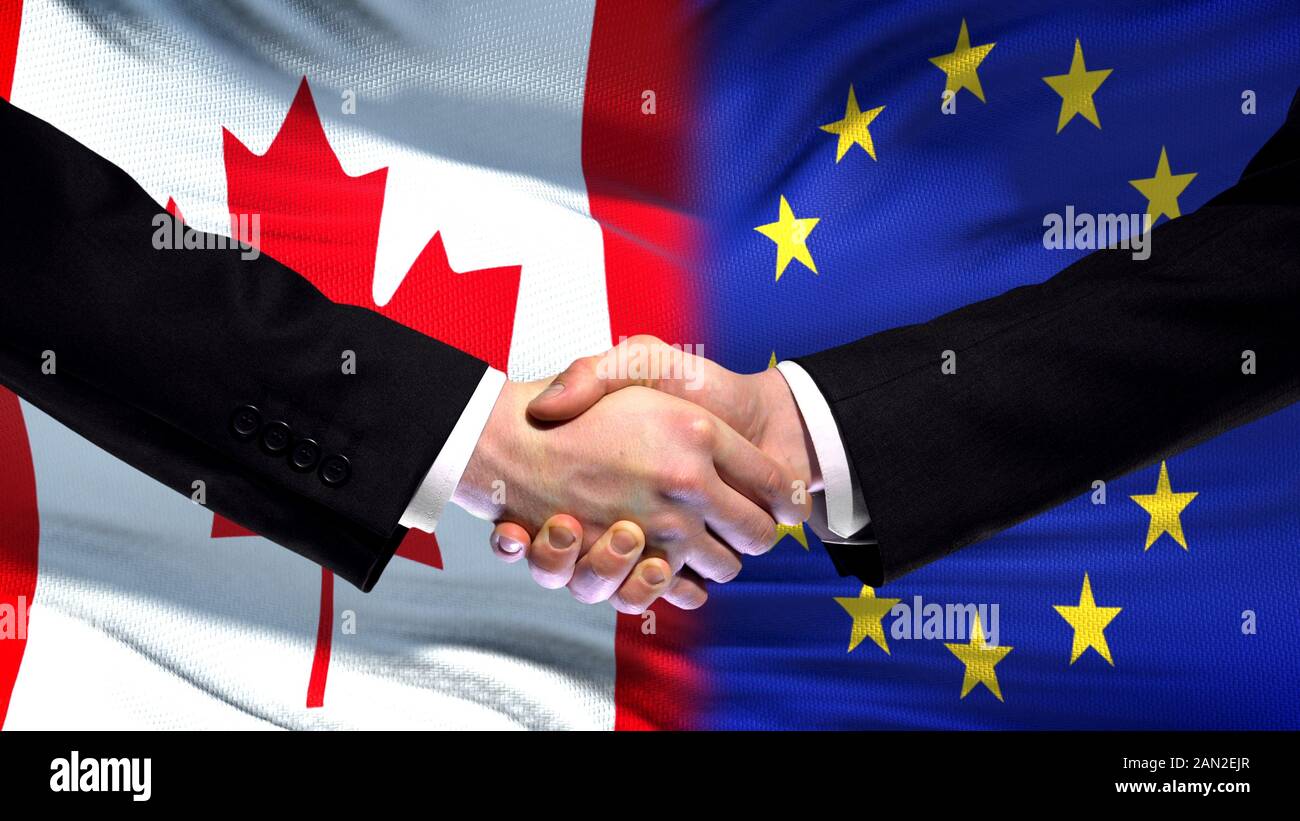 Canada and European Union handshake, international friendship, flag background Stock Photo