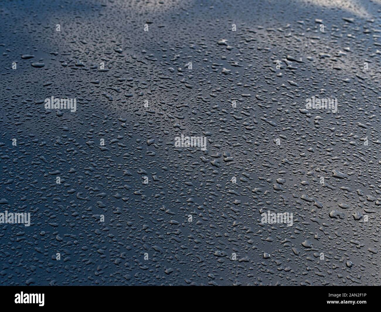 Rain drops on the blue metal plate Stock Photo