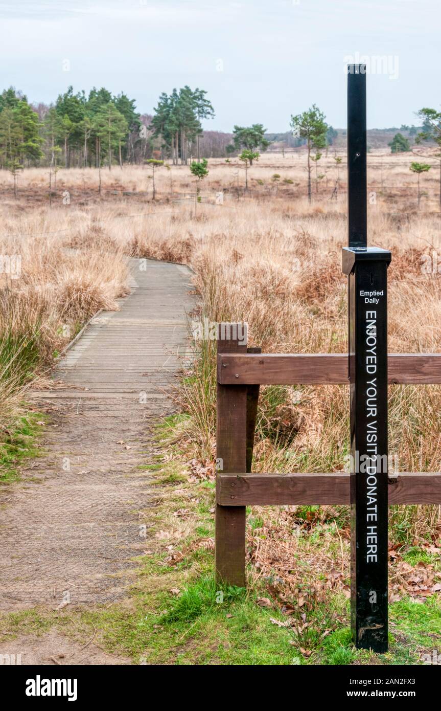 A donation post next to the boardwalk at Dersingham Bog nature reserve. Stock Photo